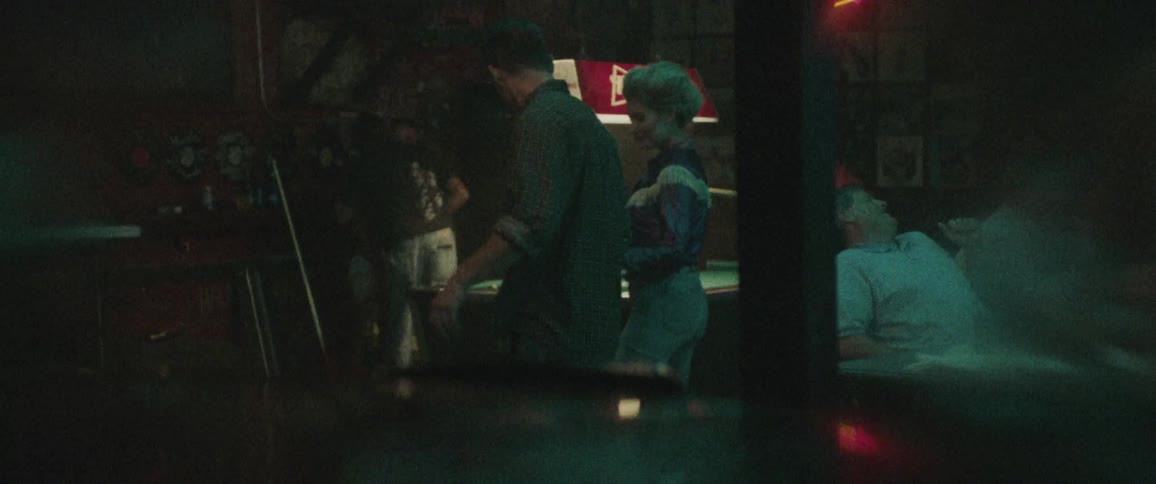 A man and woman dance by a jukebox