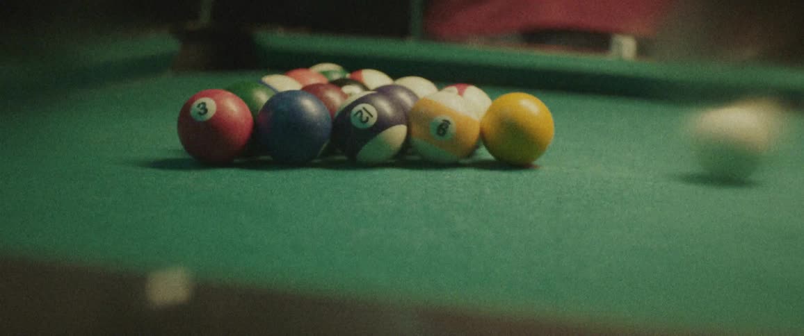 A man racks up pool balls on a pool table