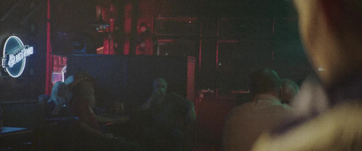 People sitting at tables watching a night club performance