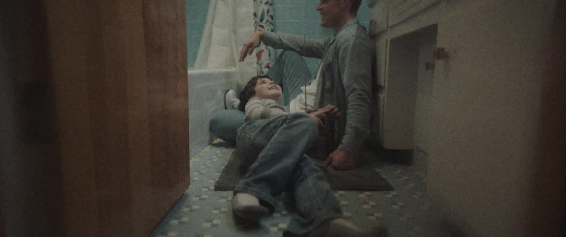 A boy sleep on his father heap