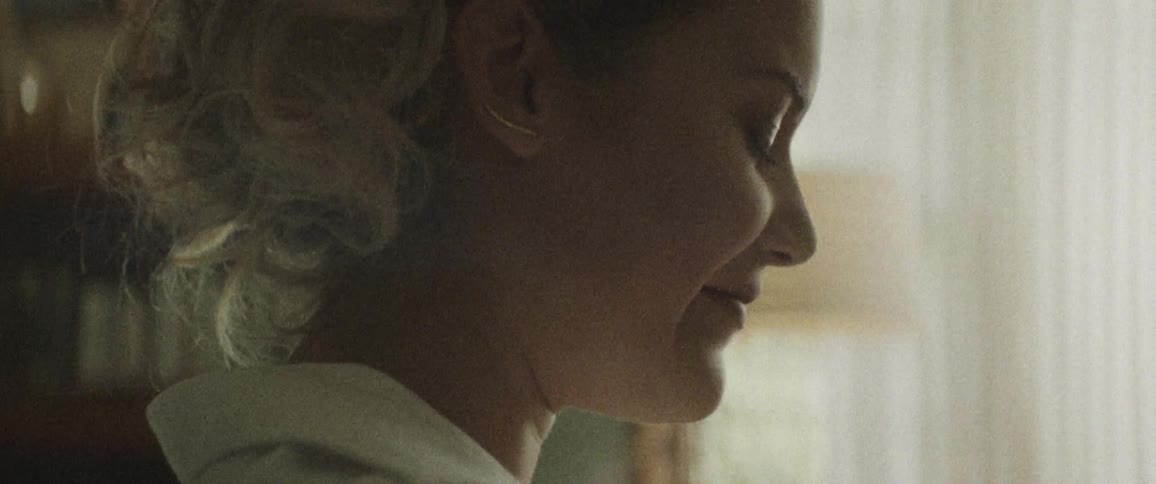 A blonde woman contemplating