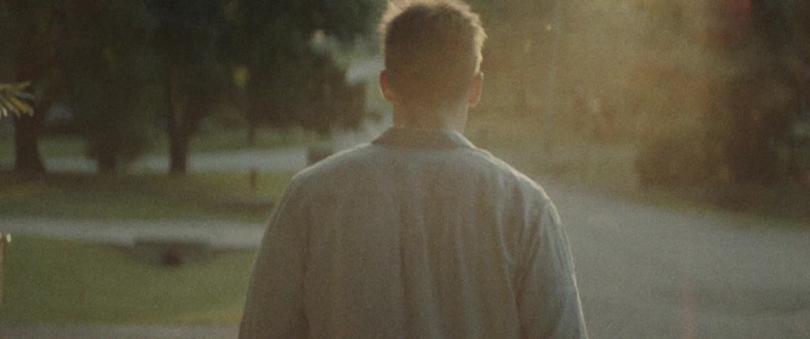 Man walks down the road in the countryside at sunset