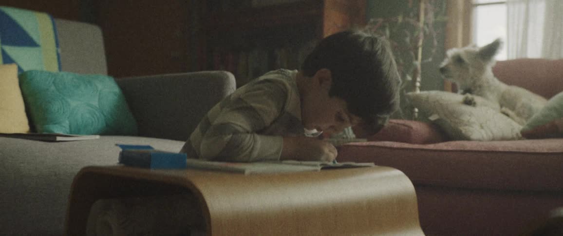 A boy writing something at his book