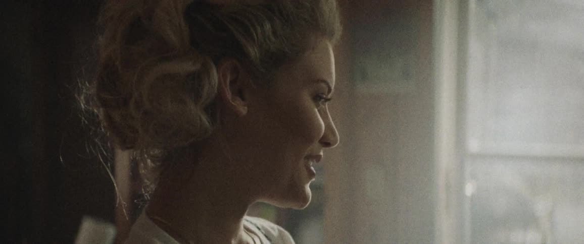 A woman smiles into the room