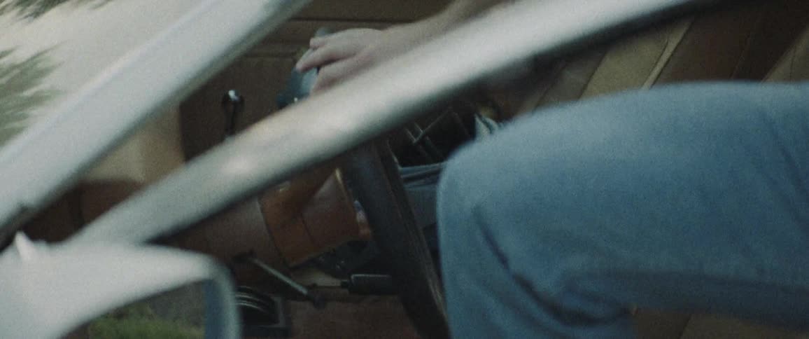 A male putting something in the car