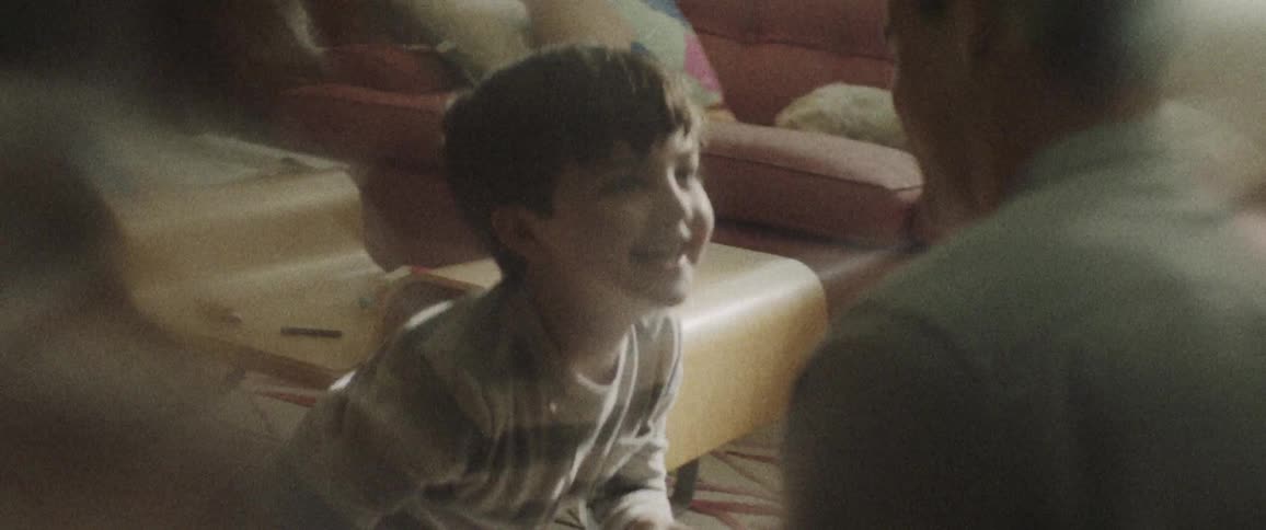 Father and son playing on the floor indoors in the living room