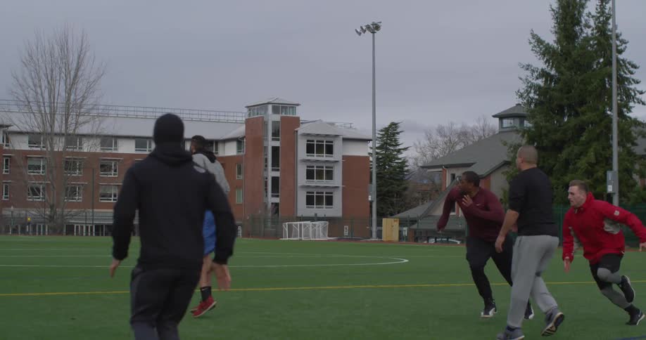 Men play football outside