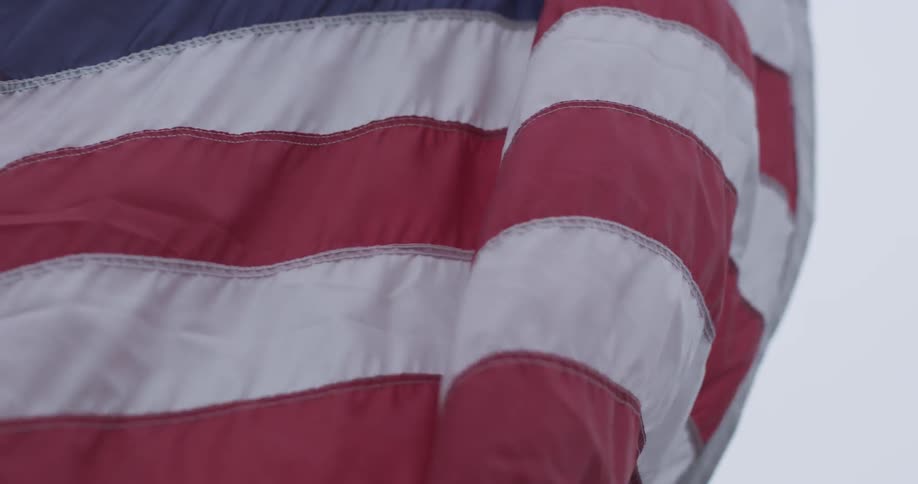 An american flag is hoisted up a flagpole