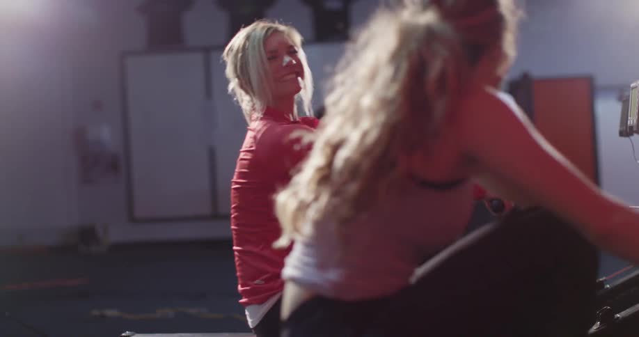 Women using rowing machines