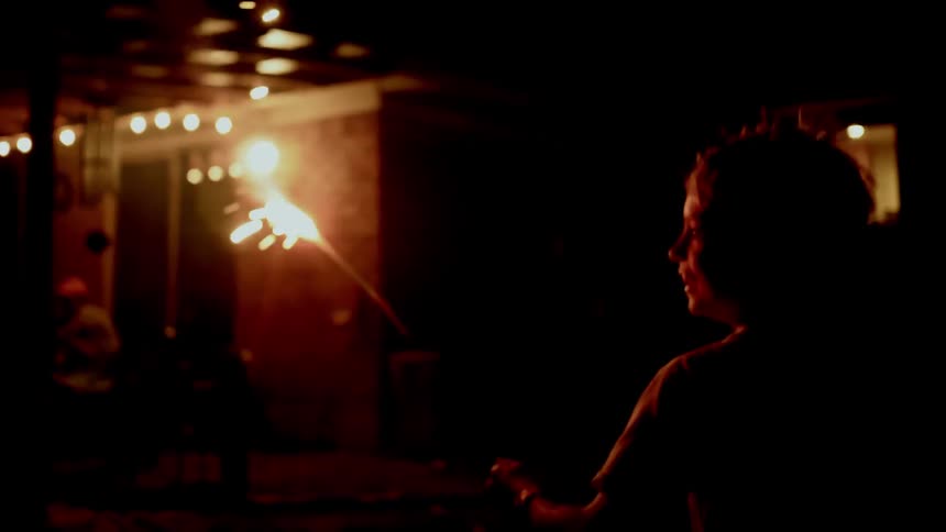 Child running with a sparkler