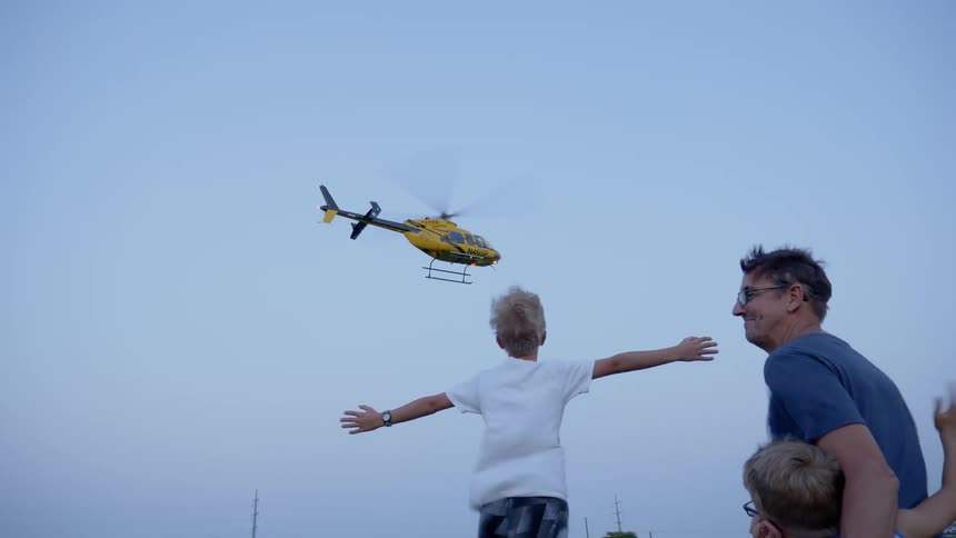 A helicopter taking off in a grass land