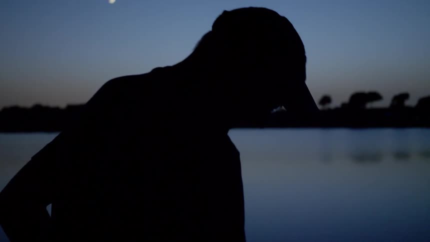 A man is walking outdoors at night