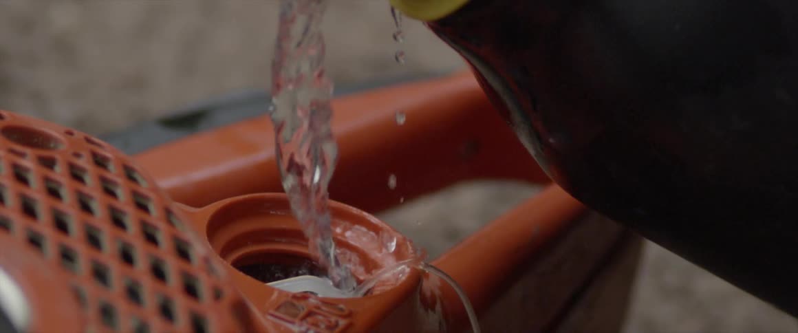 Fuel pours into a chainsaw