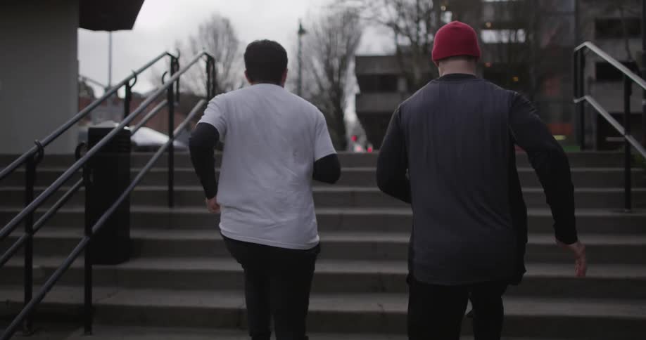 Two men running up some stairs