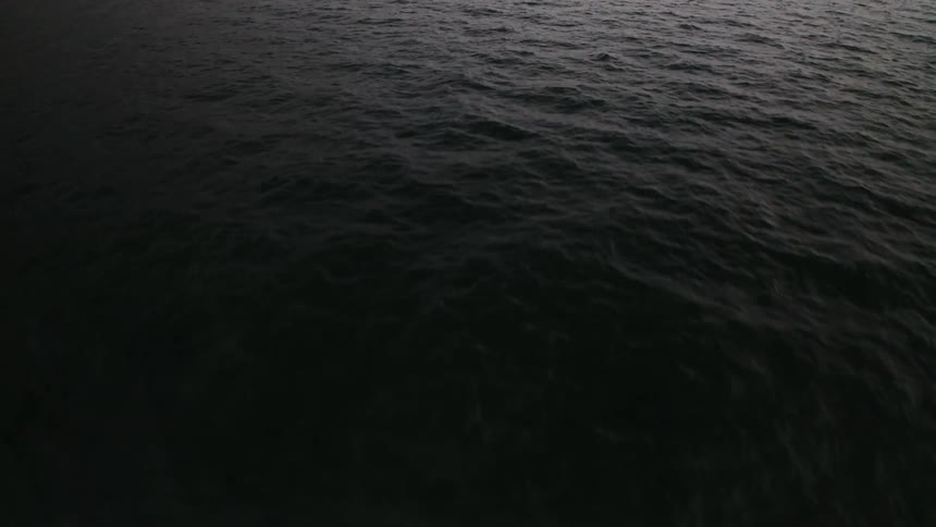 A view of an ocean at dark