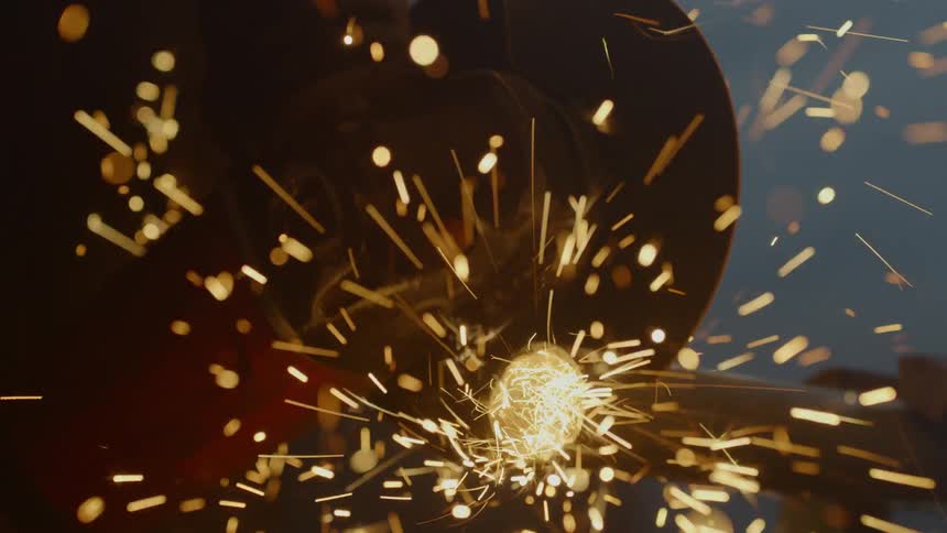 A person cutting a pipe with a buzz saw