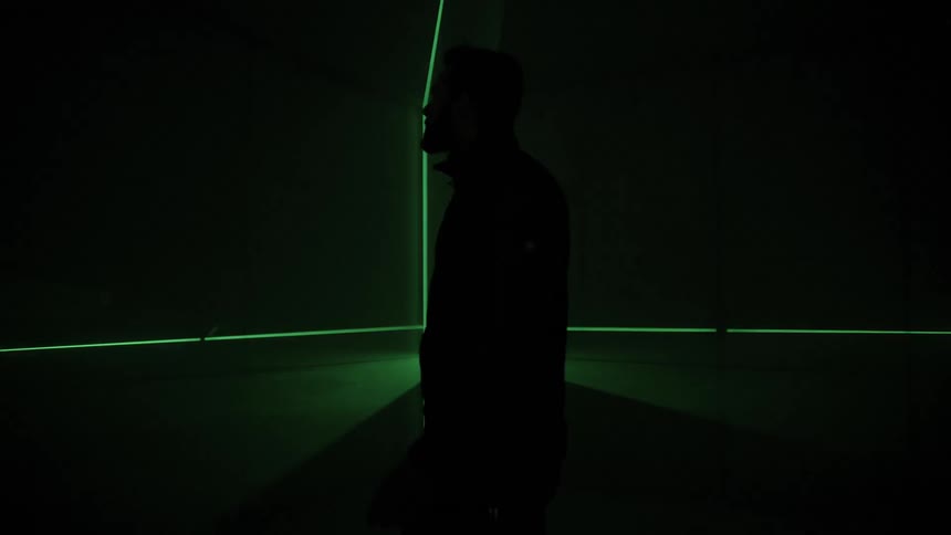 A man walking past a laser light