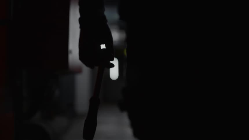 A man with gun walking trough a corridor
