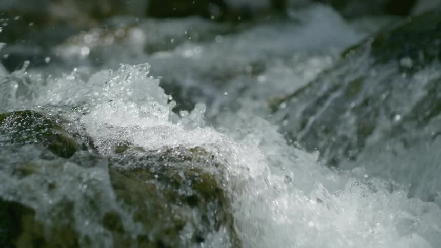 Water river flow hitting rock