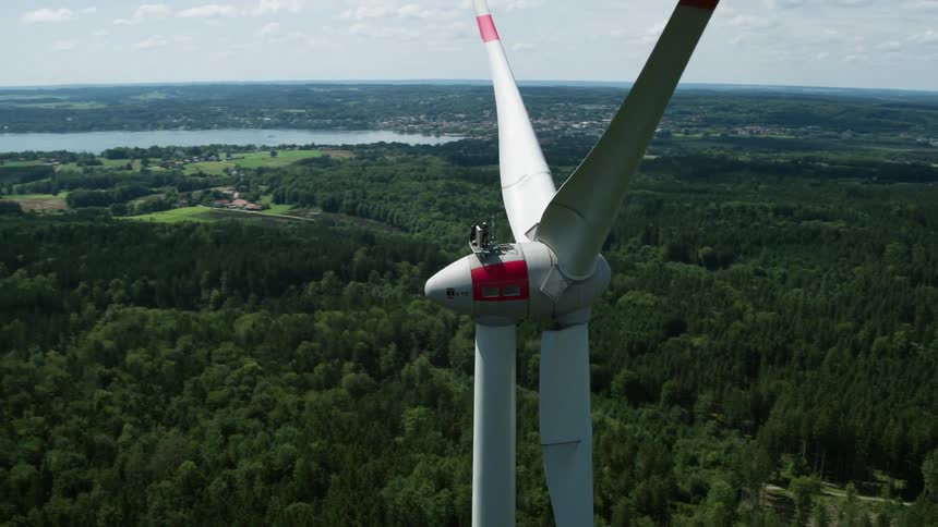 Wind turbine towers over forest