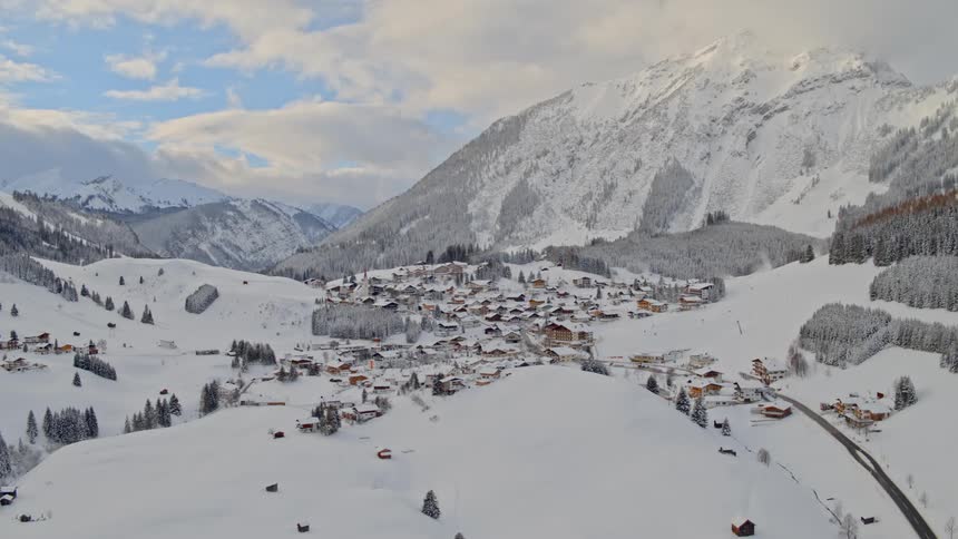 An aerial view of a village under the snowy mountain