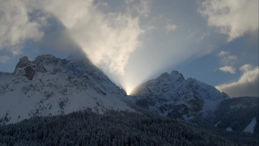 Sunlight streams through a mountain pass