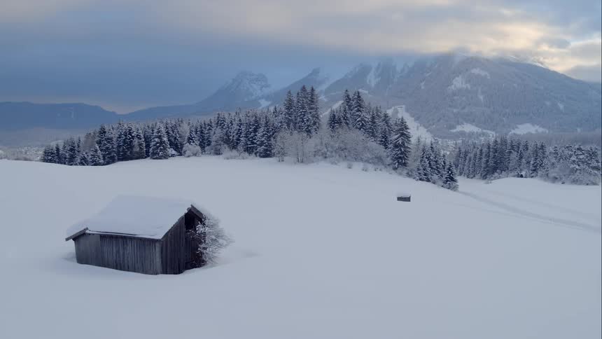 A house in the middle of snowy mountain