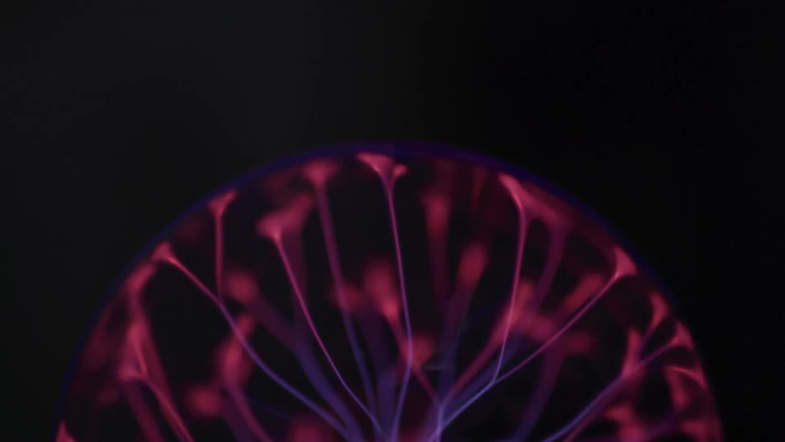 The plasma ball is flashing in the dark