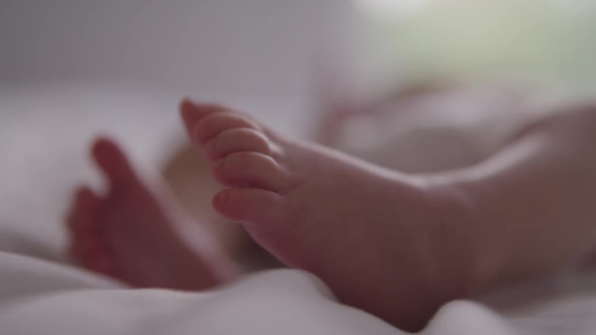 Toddler slowly moves their feet while resting