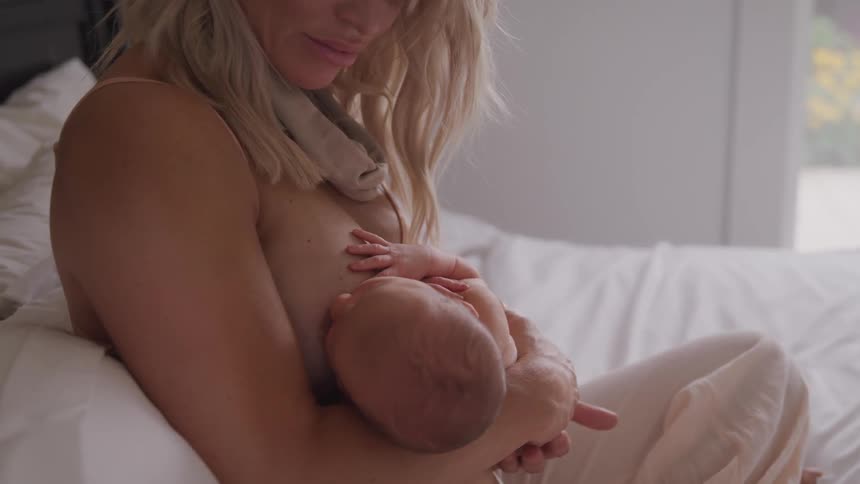 A mother breastfeeds her child