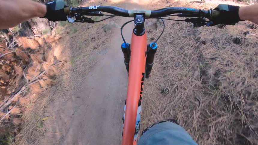 A pov of a biker going down a bike path