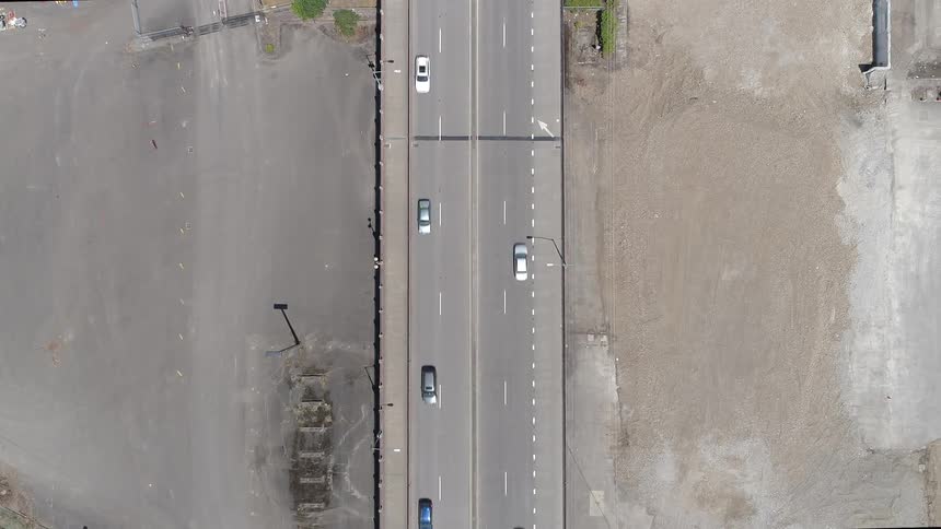 Birds eye view of cars traveling on a highway in time lapse speed