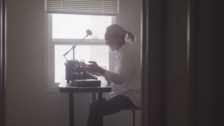 An old man typing