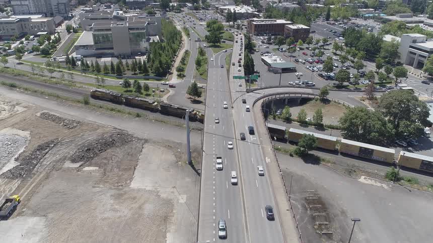 Cars are driving through a downtown city