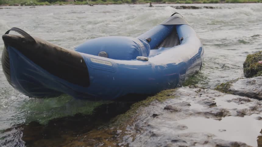 An inflatable boat is thrown into the river