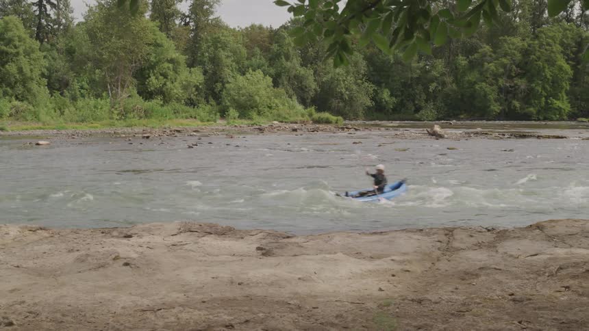 A man playing canoe at the river