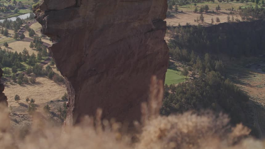 A large cliff sits in a field