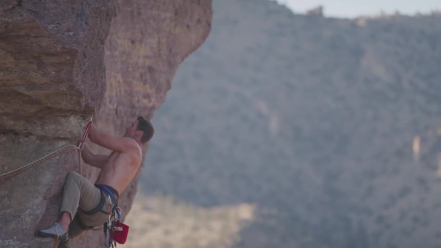 A man is climbing up a mountain