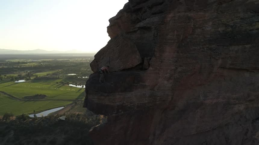 A man climbs a very steep mountain side