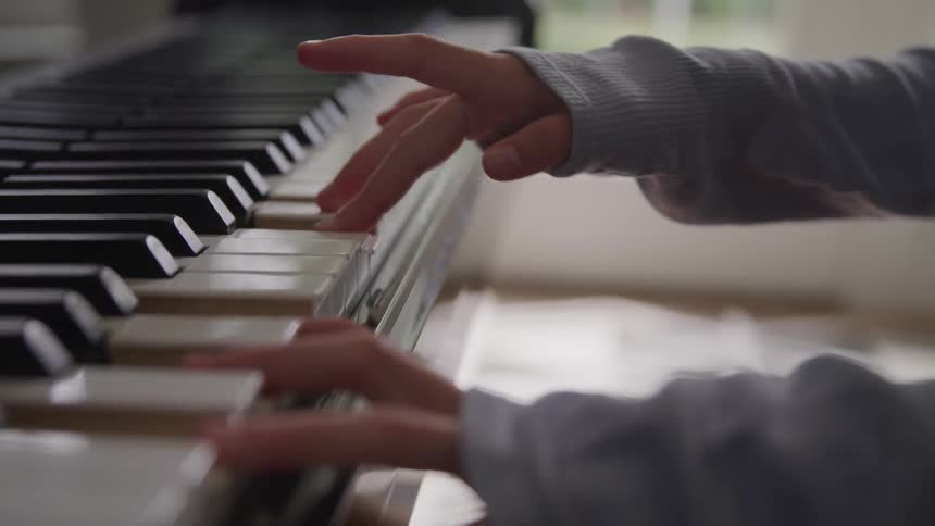 A hand playing piano