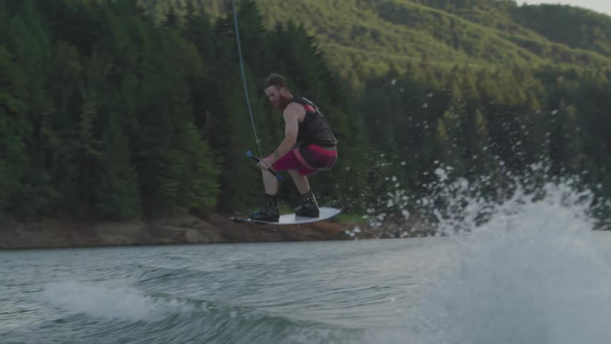 A man does a jump on water skis
