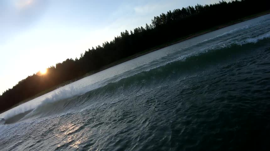 A man water skiing on a lake behind a boat
