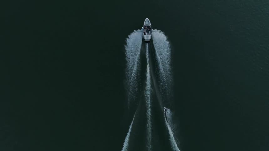 Birds eye view of a boat pulling a water skiier