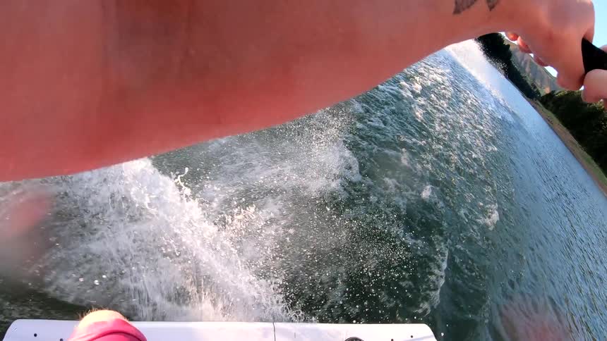A man waterskis behind a boat