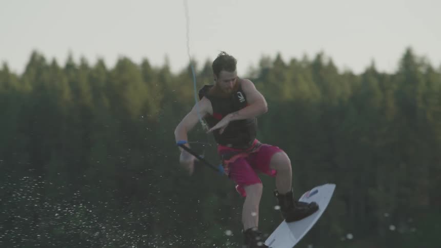 Man falling in the lake while wake boarding