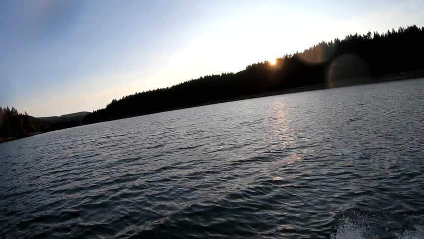 Man wakeboarding behind a boat