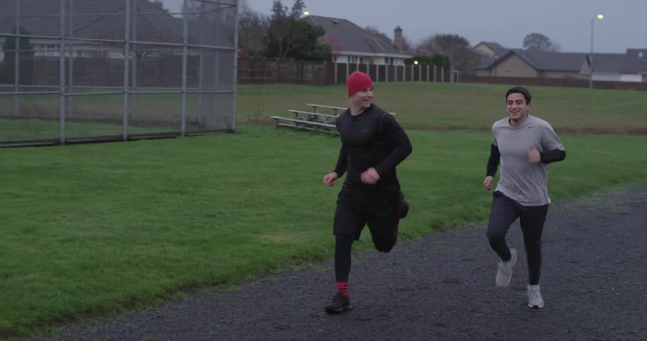 Two men run on a track