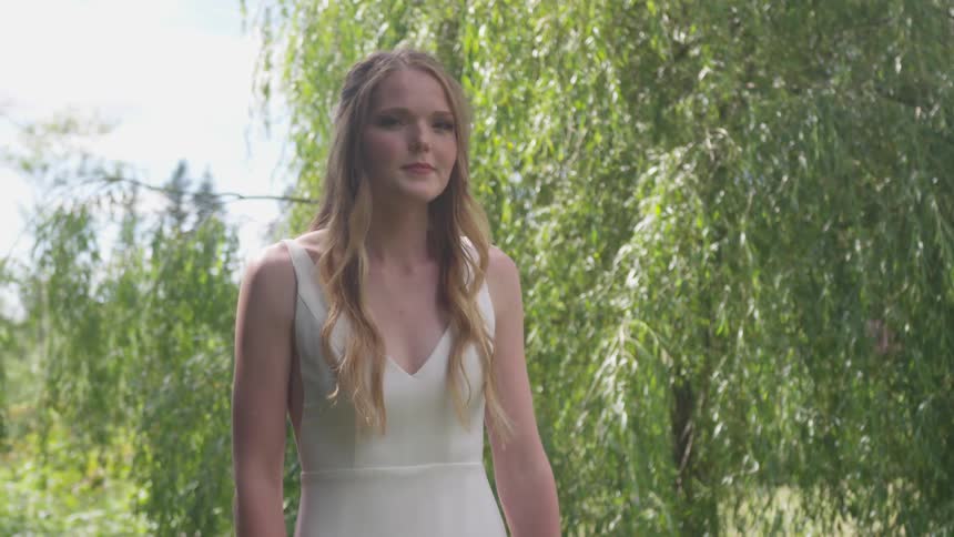 Bride turns to the camera in the forest