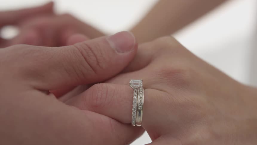 Groom and bride hold hands during the wedding ceremony