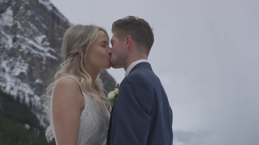 A couple kissing on the snowy mountain